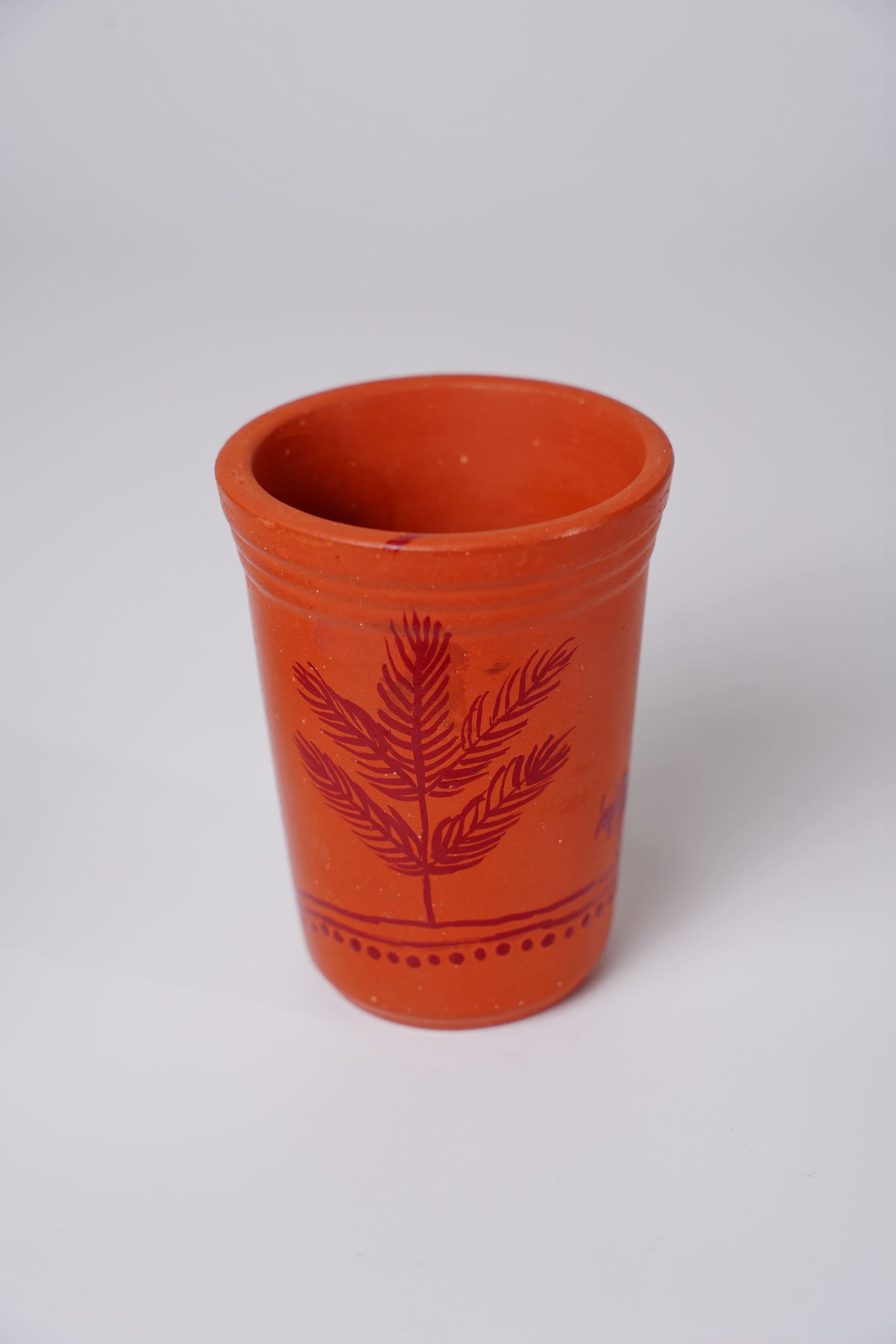 terracotta or clay glass with handpainted Warli