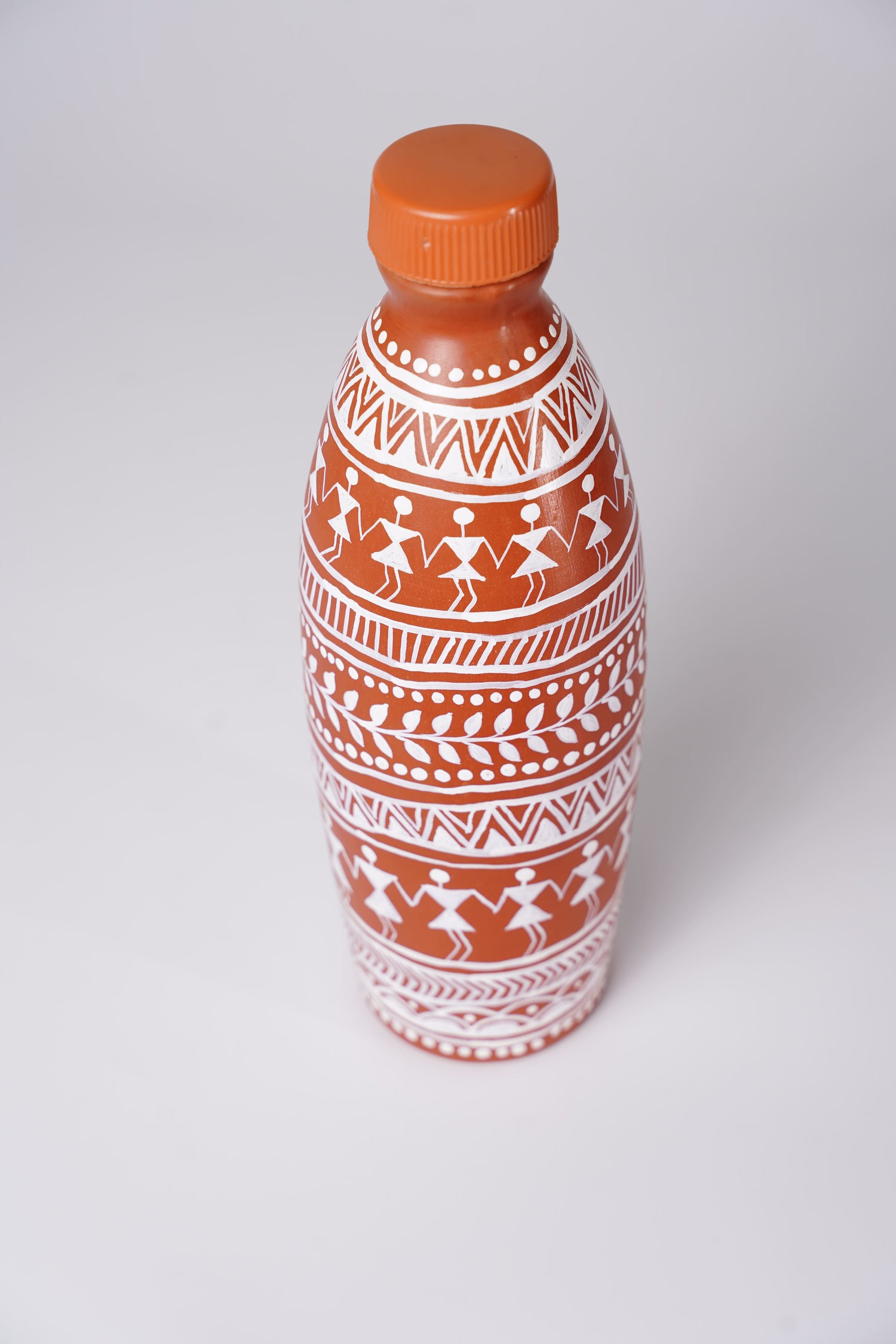 handmade clay water bottle with Warli art